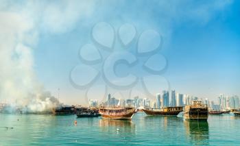 Traditional wooden boat on fire in the Persian Gulf at Doha, Qatar