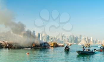 Traditional wooden boat on fire in the Persian Gulf at Doha, Qatar