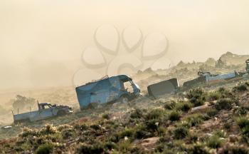 Broken down abandoned rusty cars in the Tunisian countryside. Tataouine - Tunisia, North Africa