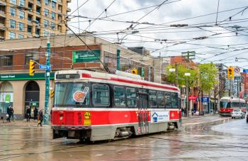 Toronto, Canada - May 2, 2017: Old streetcar on a street of Toronto. The Toronto streetcar system is the largest and the busiest light-rail system in North America