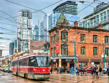 Toronto, Canada - May 2, 2017: Old streetcar on a street of Toronto. The Toronto streetcar system is the largest and the busiest light-rail system in North America
