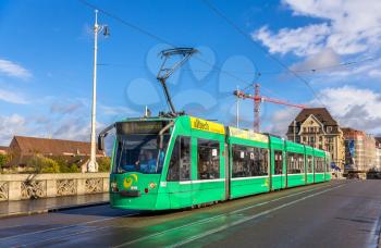 BASEL, SWITZERLAND - NOVEMBER 03: Siemens Combino tram on Middle Bridge on November 03, 2013 in Basel , Switzerland. Basel tram network consists of 12 lines