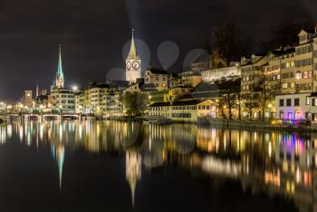 Zurich on banks of Limmat river at winter night
