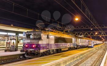 LYON, FRANCE - JANUARY 07: Electric locomotive with a regional train on January 7, 2014 at Lyon Part-Dieu railway station. The station was constructed in 1978 as part of the new Part-Dieu urban neighborhood project