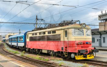 Old electric locomotive with a passenger train at Brno Central Station, Czech Republic