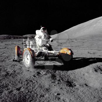 Royalty Free Photo of an Astronaut Driving the Rover on the Moon 