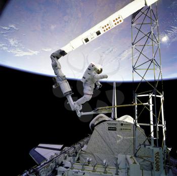 Royalty Free Photo of Astronaut Bruce McCandels working on the STS-41-B
