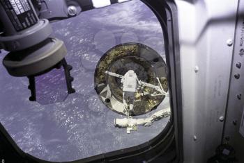 Royalty Free Photo of an Astronaut doing repairs to the Horizon Satellite 