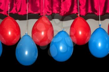 Red and blue balloons on a dark background