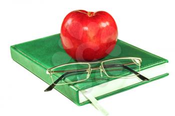 Apple and glasses on a book isolated on white background