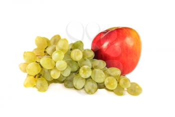 Bunch of white grapes and an apple on a light background