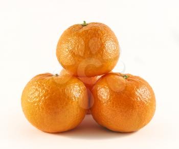 Slide the four ripe tangerines on a white background