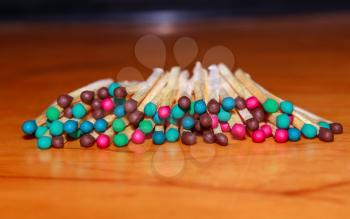 Matches with different color head on the wooden background