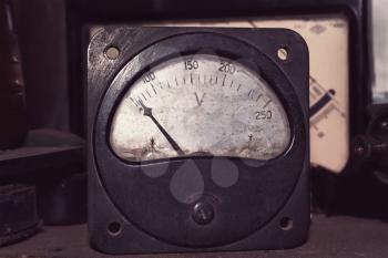 Old big voltmeter stylized as retro photo