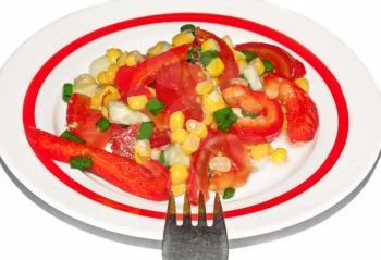 Plate with a salad of tomatoes, peppers and corn on a white background