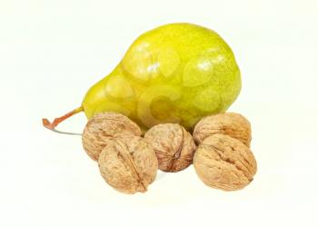 Ripe pear and walnuts isolated on a white background