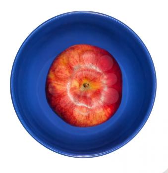 Red apple in a blue bowl on a white background