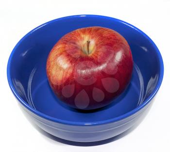 Red apple in a blue bowl on a white background