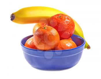 Tangerines and banana in a blue bowl on a white background