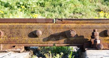 Joint of rusty railway rails close up