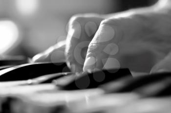 Stylized hand of pianist  in motion close-up in black and white