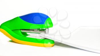 Bright stapler and paper pack on a white background