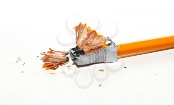 Broken pencil and pencil sharpener on a light background