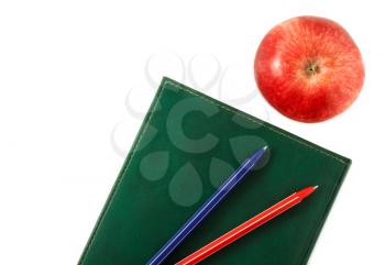 Red apple diary and pen isolated on white background