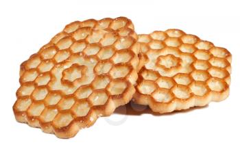 Several honey cookies in the form of honeycombs on a white background