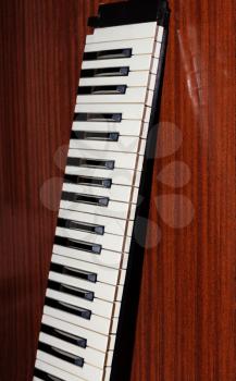 Part of the music keyboard on a wooden background