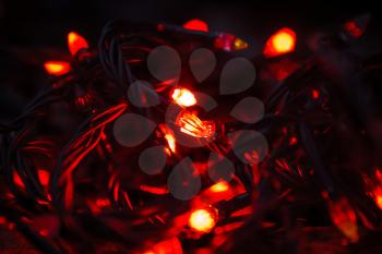 Background of colored lights garlands in the dark
