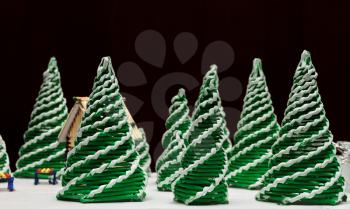 Toys spruces and a house on a dark background