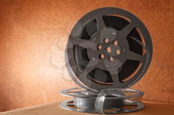 Two coils with a film on a wooden background