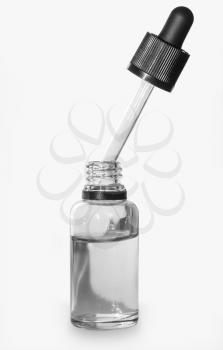 Glass bottle with pipette close up isolated on a light background