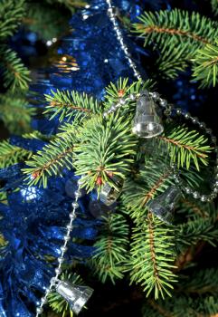 Spruce branch with garland and tinsel close up