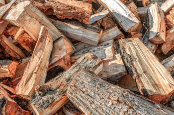 Pile of chopped firewood on a sunny day close up