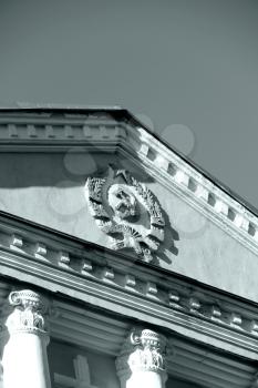 Emblem of USSR on the building. Part of the roof. Monochrome image