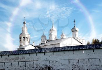 Spaso-Prilutsky Monastery in the Vologda city, Russia. Blue sky and green grass. Castle defense wall