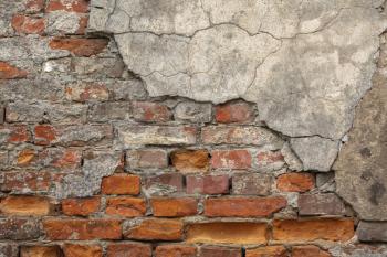 Texture of old brick wall with chipped plaster