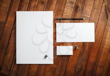 Blank corporate identity template on wooden table background. Photo of blank stationery set. Mockup for design presentations and portfolios. Top view.