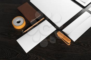 Fragment of blank stationery and corporate identity template on wooden background.  For design presentations and portfolios.