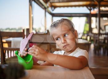 Portrait of a serious child girl. Shallow depth of field. Selective focus on child's face.