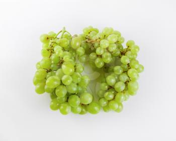 Two bunches of ripe tasty sweet green grapes. Top view.