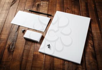 Photo of blank stationery set on wooden table background. Blank stationery template for branding identity for designers.