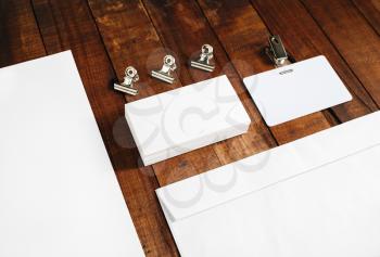 Close-up of blank letterhead, business cards and envelope. Blank stationery set on vintage wooden table background. Blank template for your design.