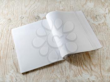Blank booklet on wooden textural background with soft shadows. Mock-up for graphic designers portfolios.