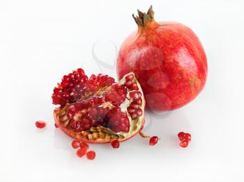 Delicious juicy ripe pomegranate and its half. Studio shot.