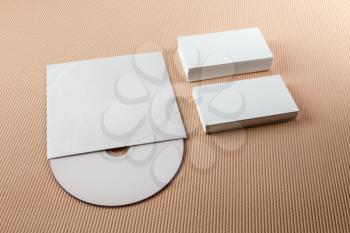 Blank business cards and CD on a beige striped background. Template for branding identity.