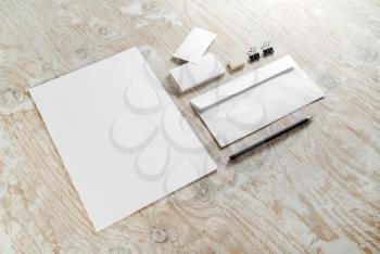 Blank stationery set on light wooden background. For design presentations and portfolios. Top view.