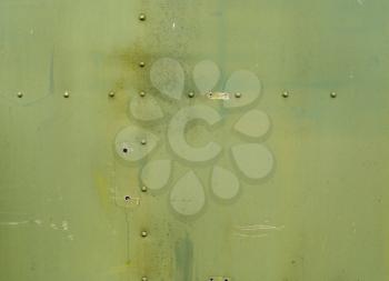 Abstract painted matte green metal background texture with rivets. Riveted  military green metal.